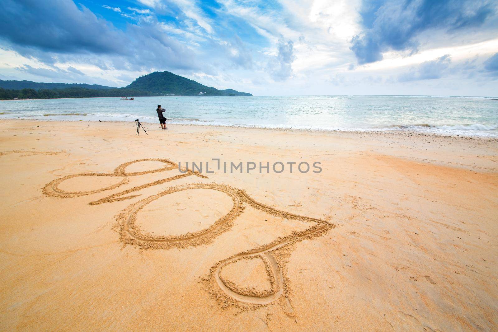 Year 2018 written at the sand beach with sea wave water