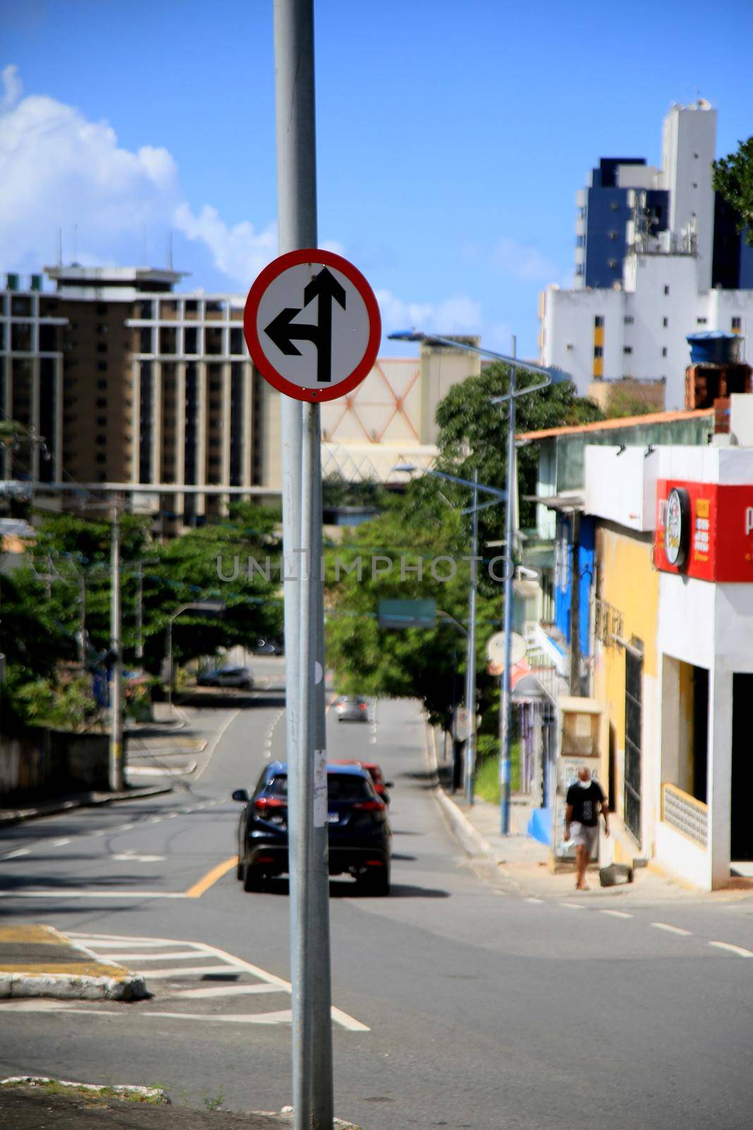 salvador, bahia, brazil - july 20, 2021: traffic sign indicating to go ahead or turn left into a street in the city of Salvador.