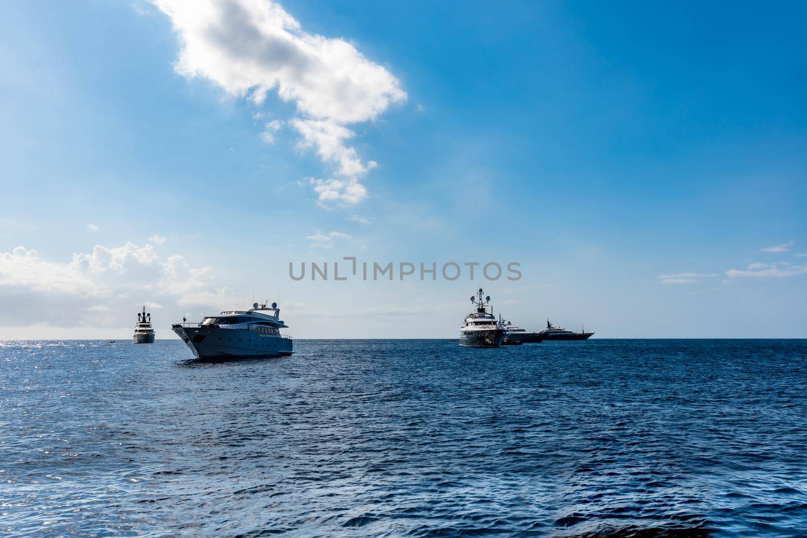 Few boats standing on the sea at sunny day by Wierzchu