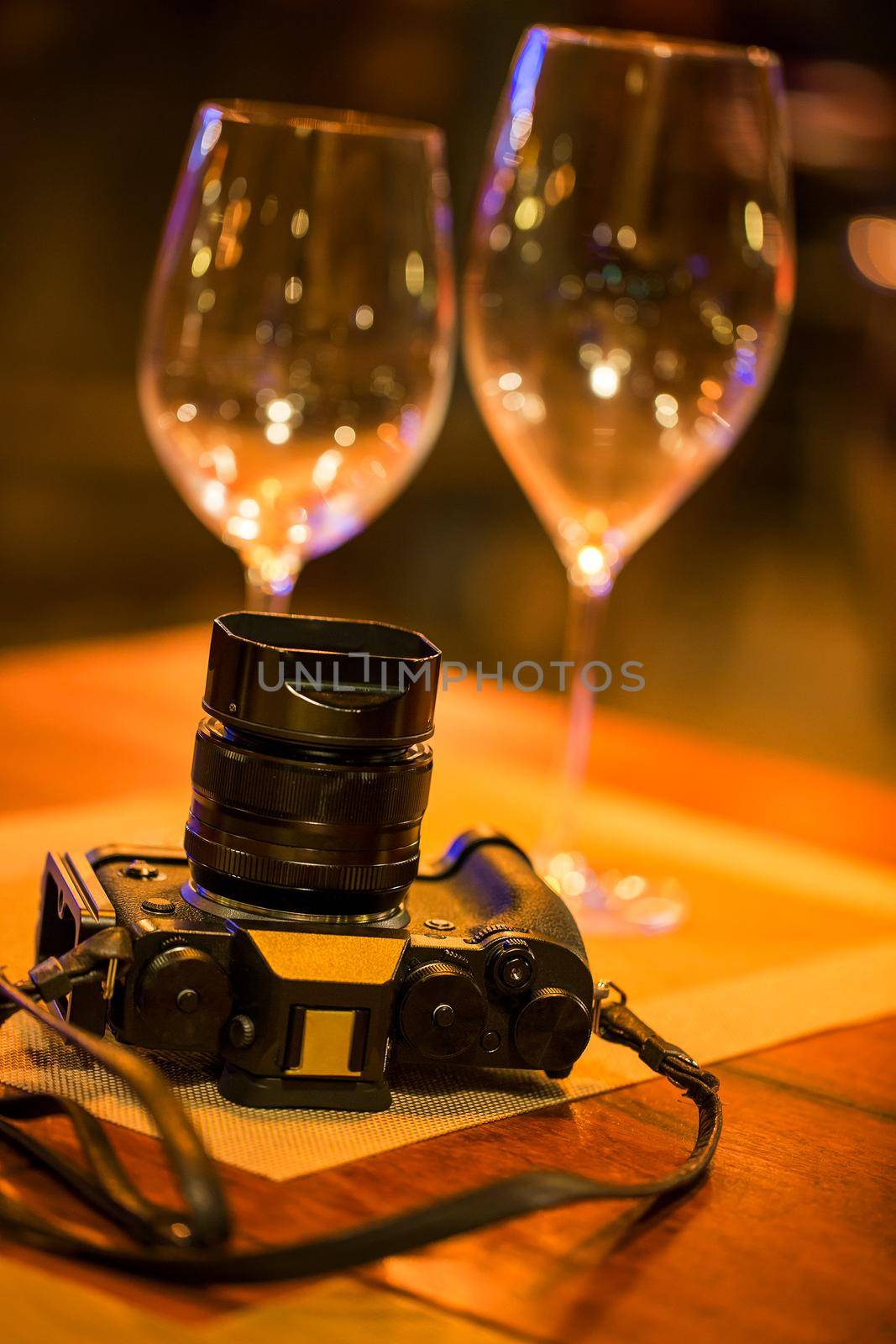 Camera on wooden table in restaurant by titipong