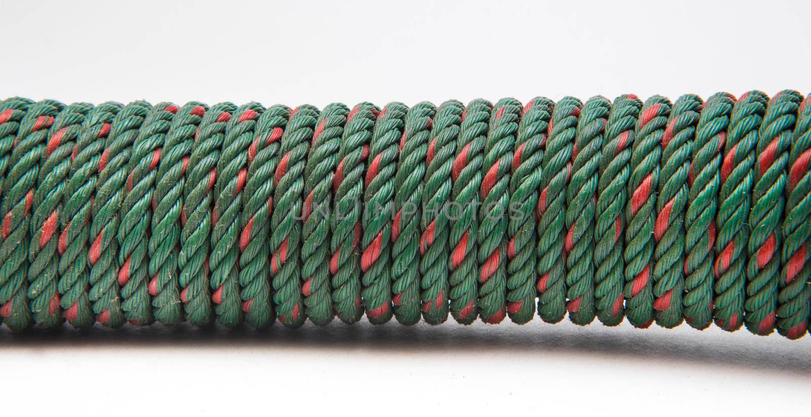 Green nylon rope on a white ground