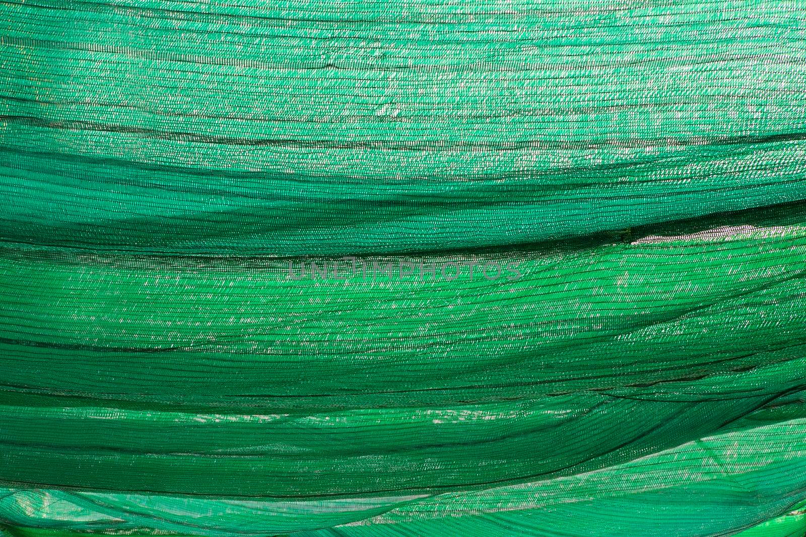 Background of green polyester fabric mesh for protection against the sun