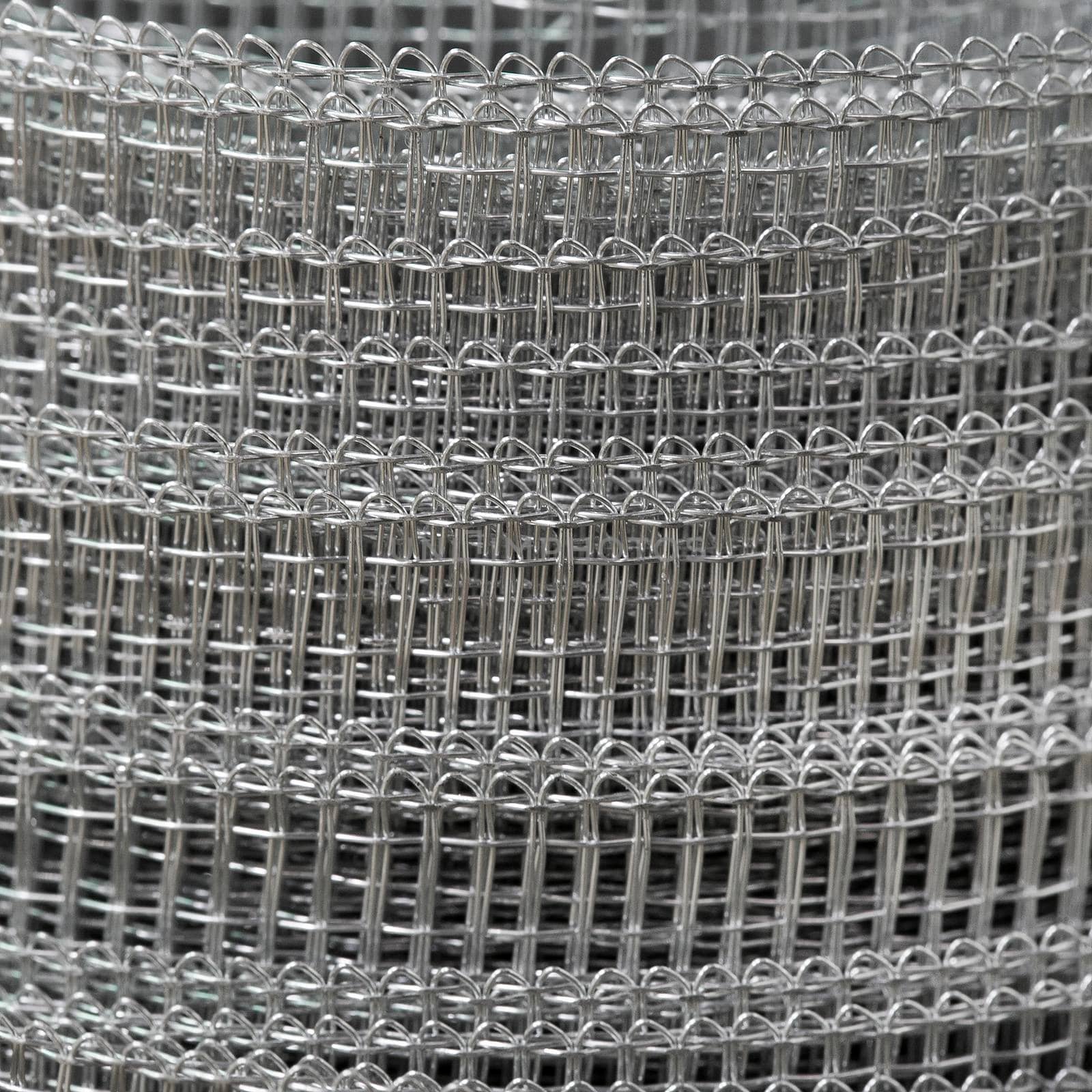 Background. Roll of a metal grid close up. by titipong