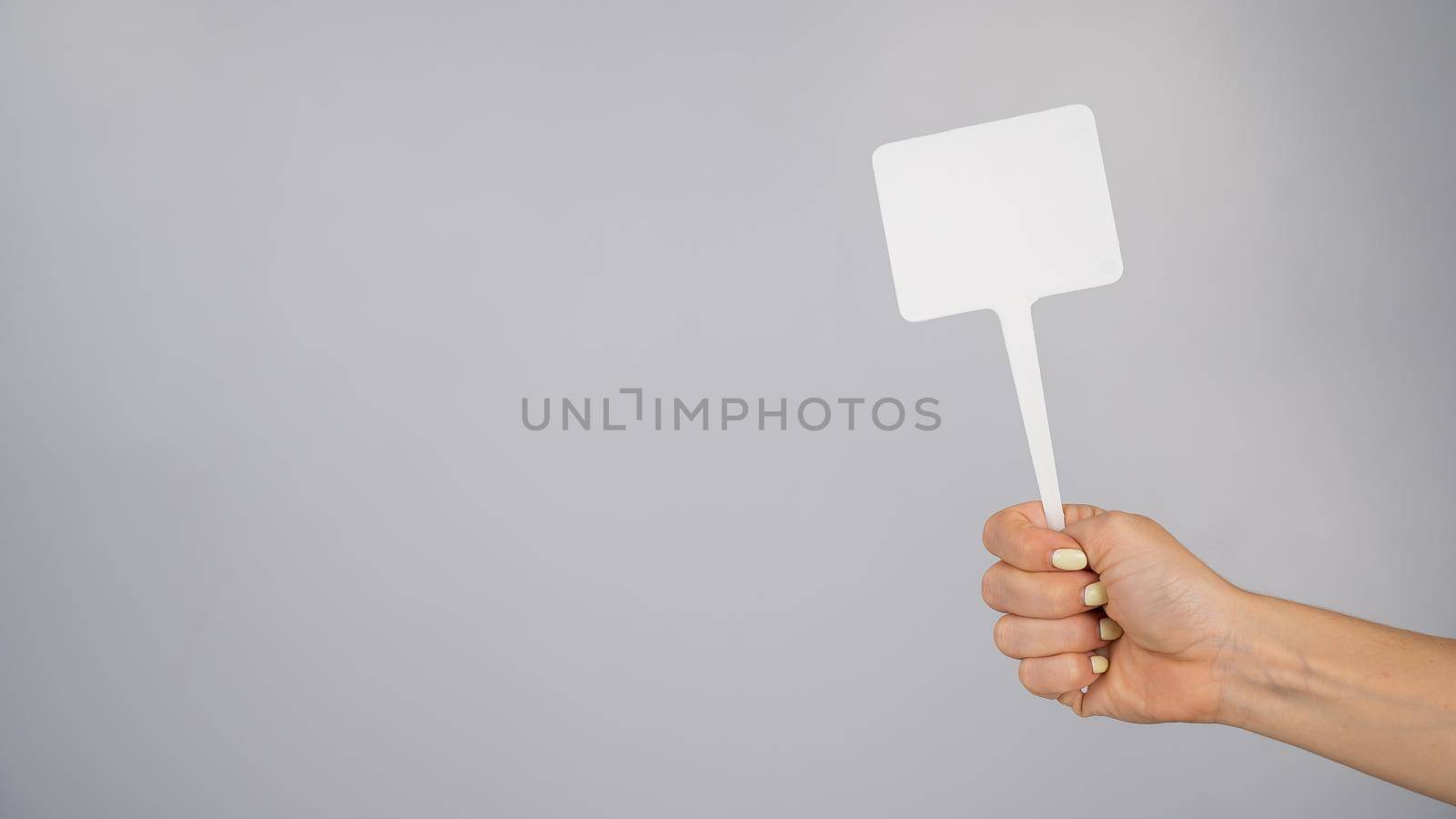 Woman holding blank sign on white background. Copy space