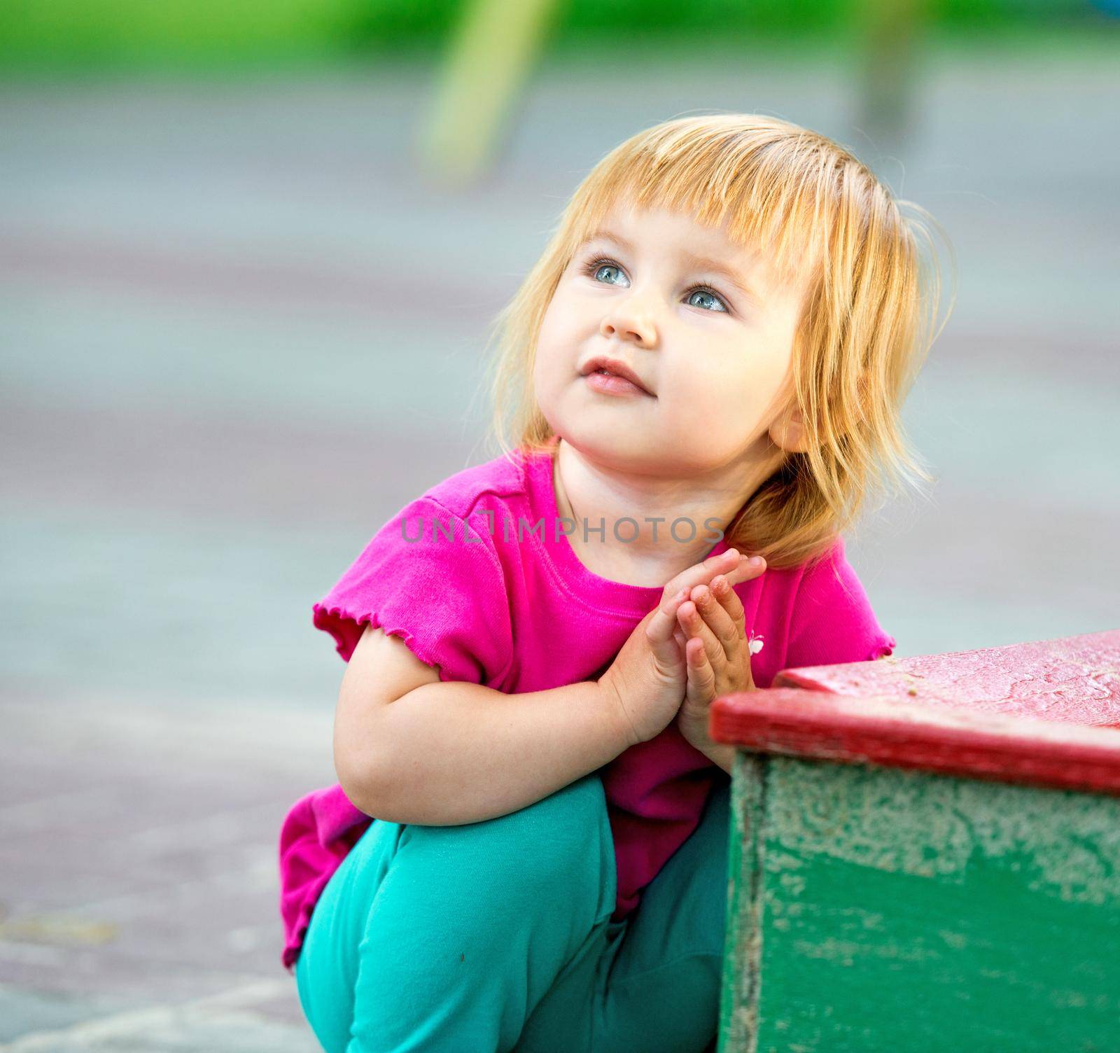 Portrait of two-year child at playground area in summer