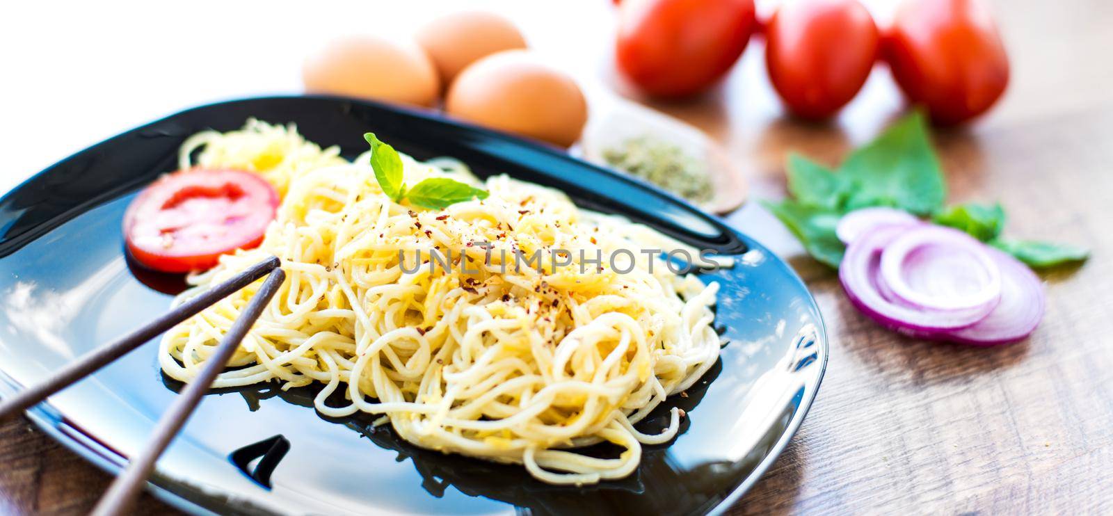 Tasty spaghetti dinner with sauce and basil