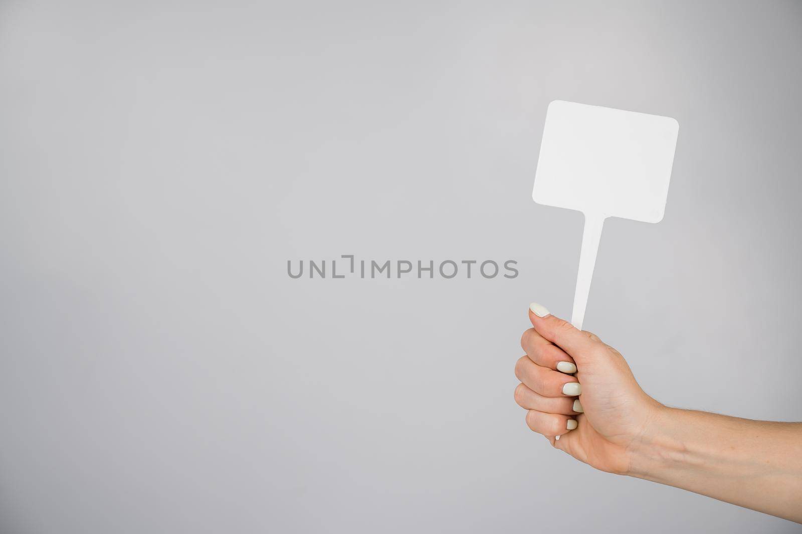 Woman holding blank sign on white background. Copy space