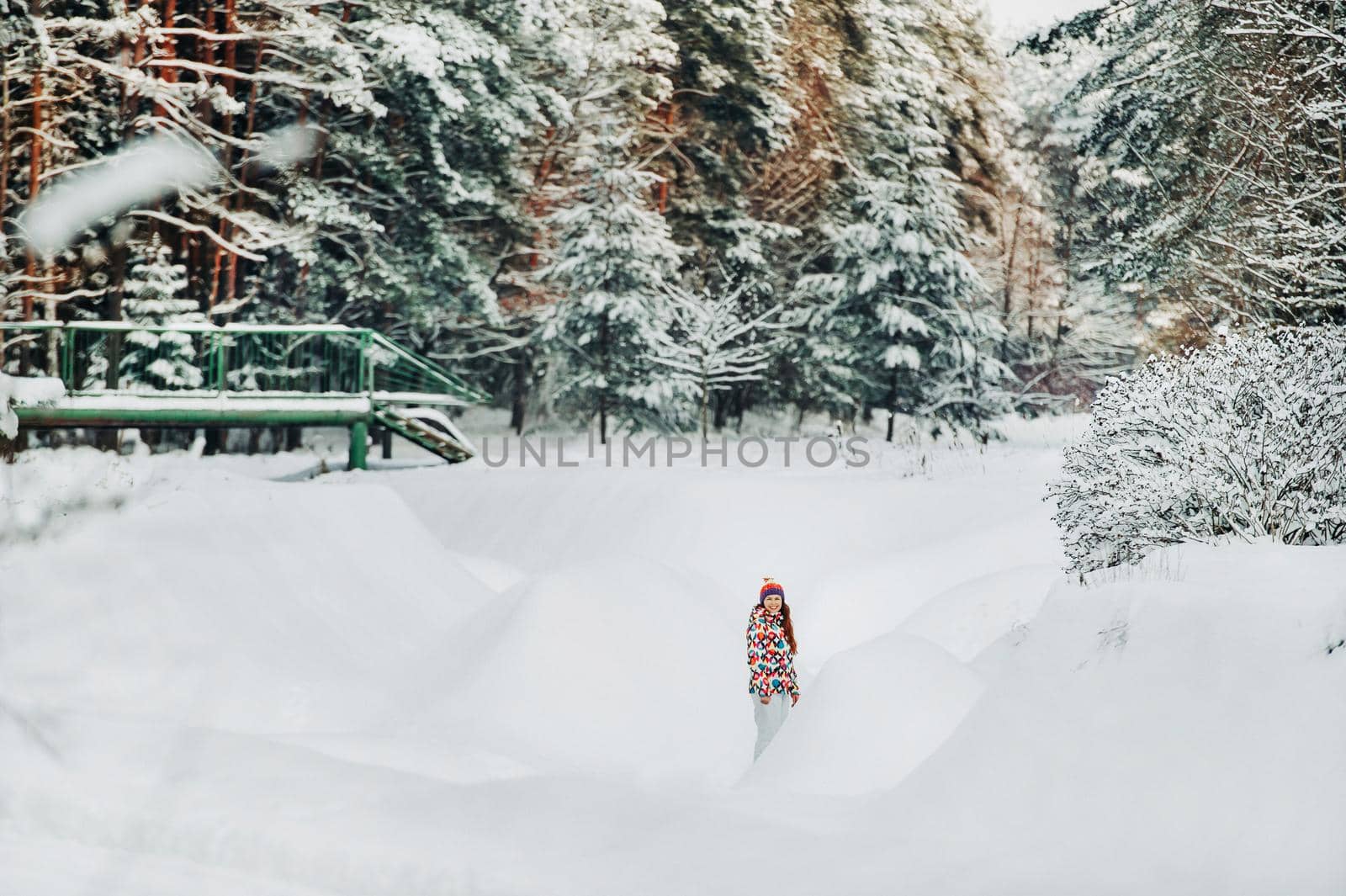 Portrait of a woman in gray clothes in a winter forest.Girl in the new year's snow-covered forest. by Lobachad