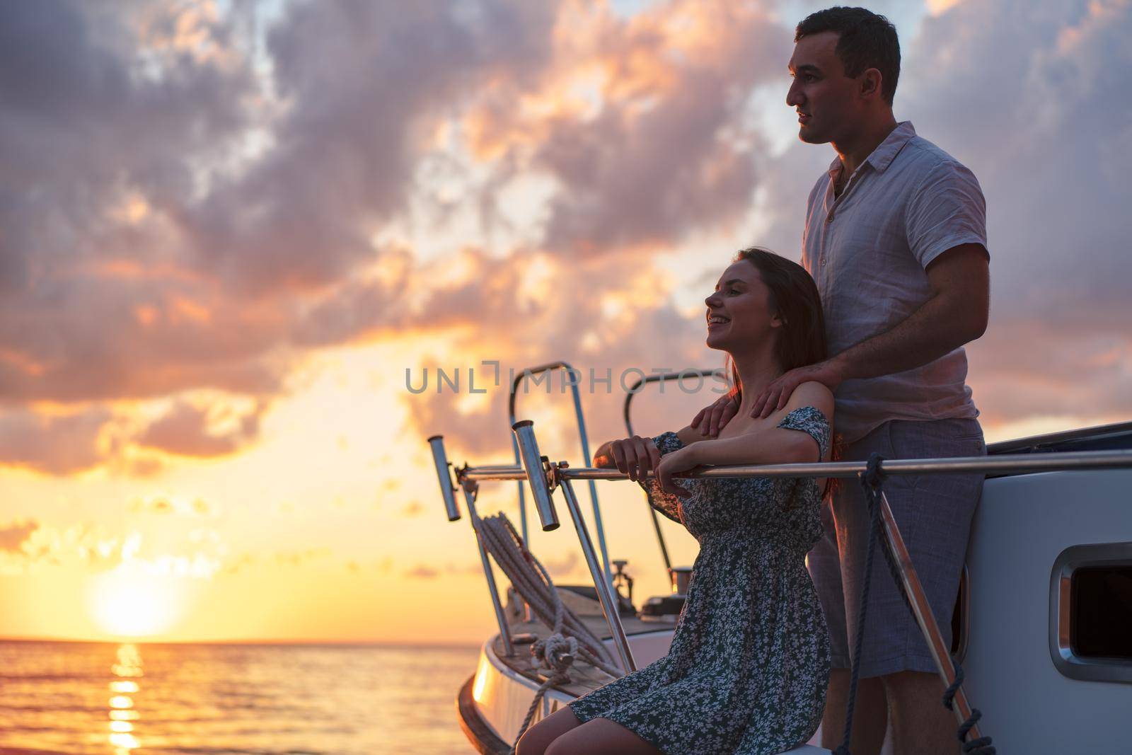 Loving couple spending time on a yacht at the open sea