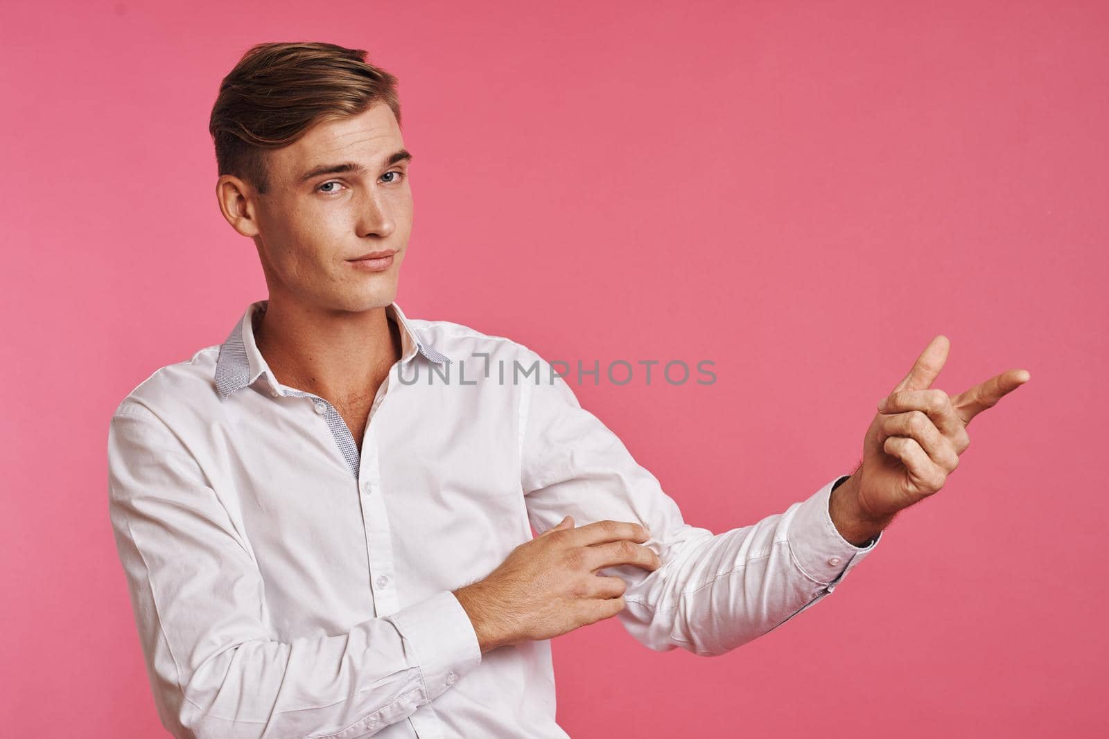 portrait of a man fashion hairstyle hand gestures modern style isolated background. High quality photo