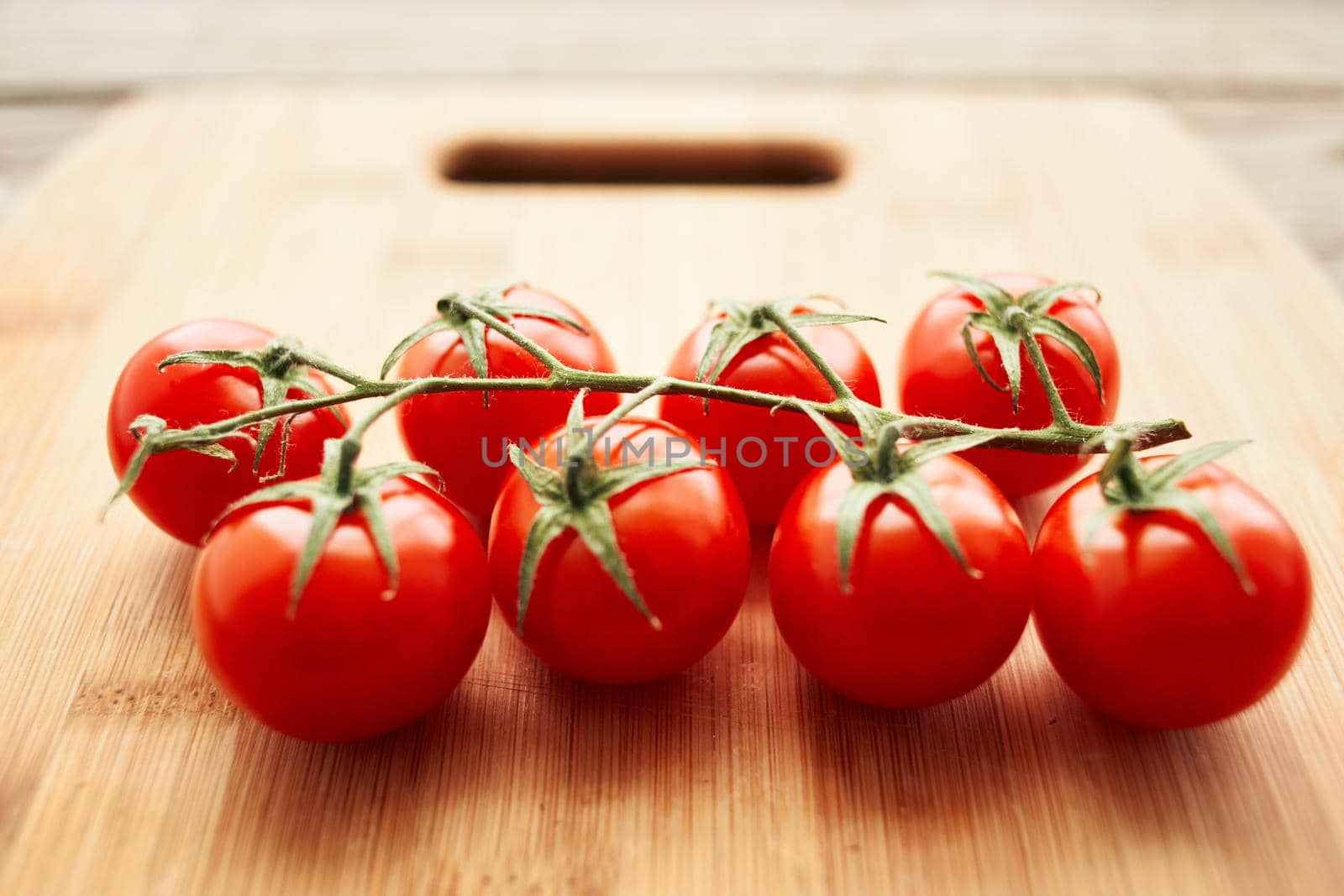 cherry tomatoes on a branch fresh food ingredients for salad by Vichizh