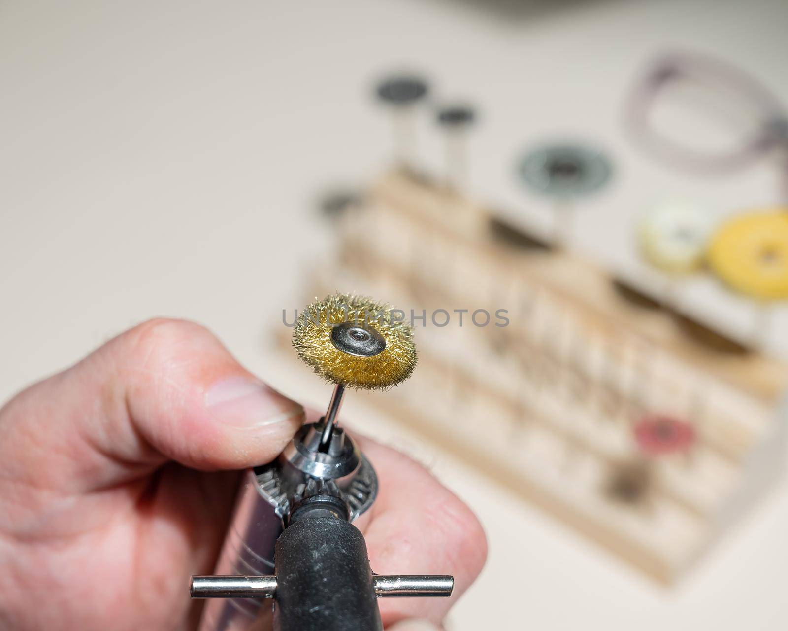 An optician technician polishes the frame of glasses. A professional optician fixes glasses