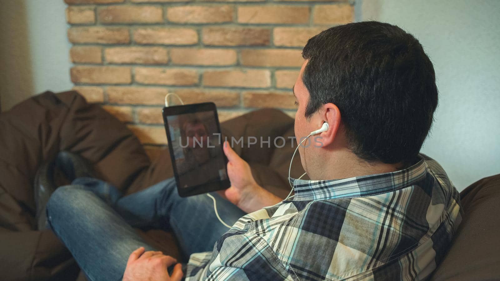 Man using tablet for talk. video chat by VadosLoginov