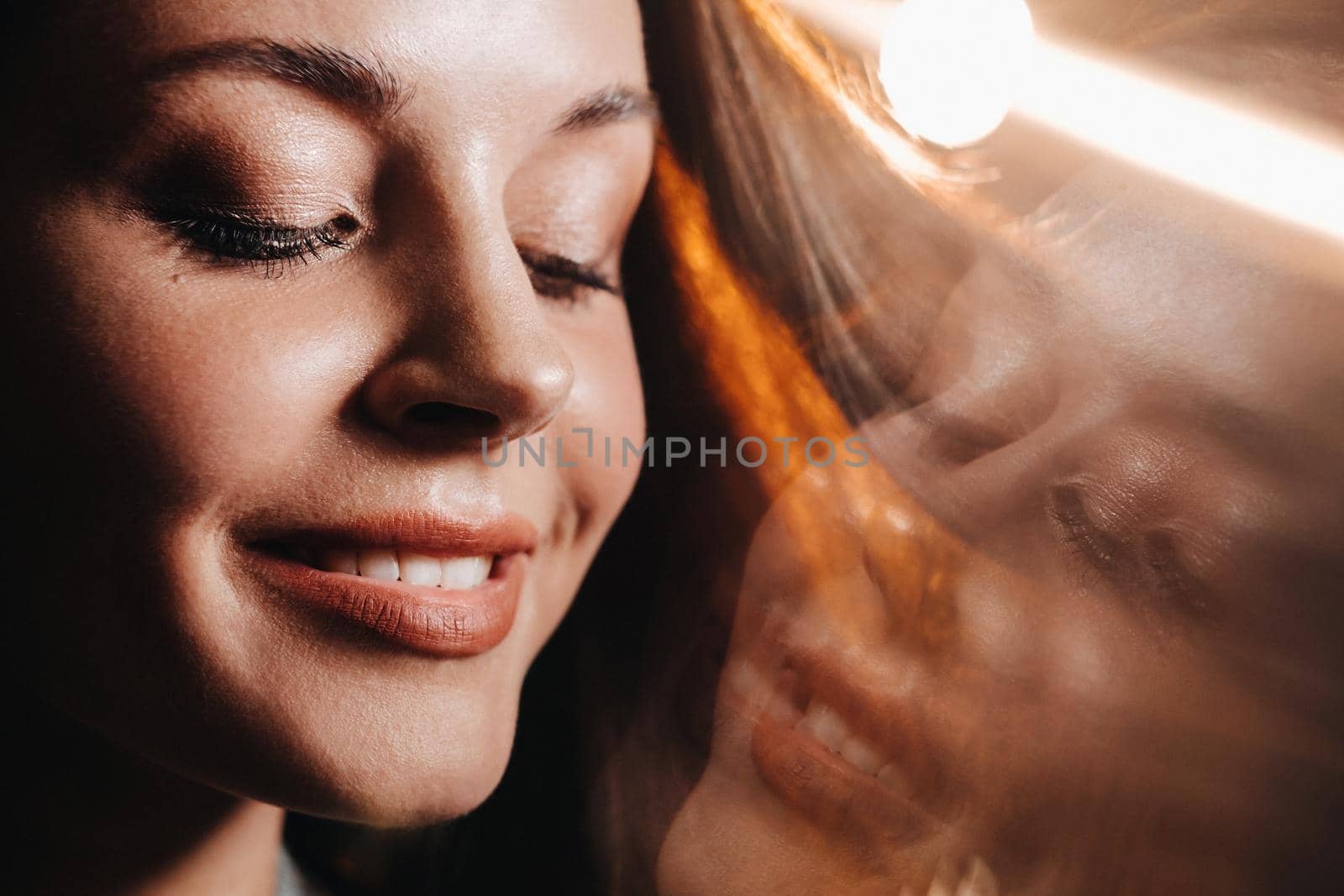 Portrait of a young European girl with long hair in a coffee shop in the evening light, a tall Girl in a jacket with long hair in a cafe by Lobachad