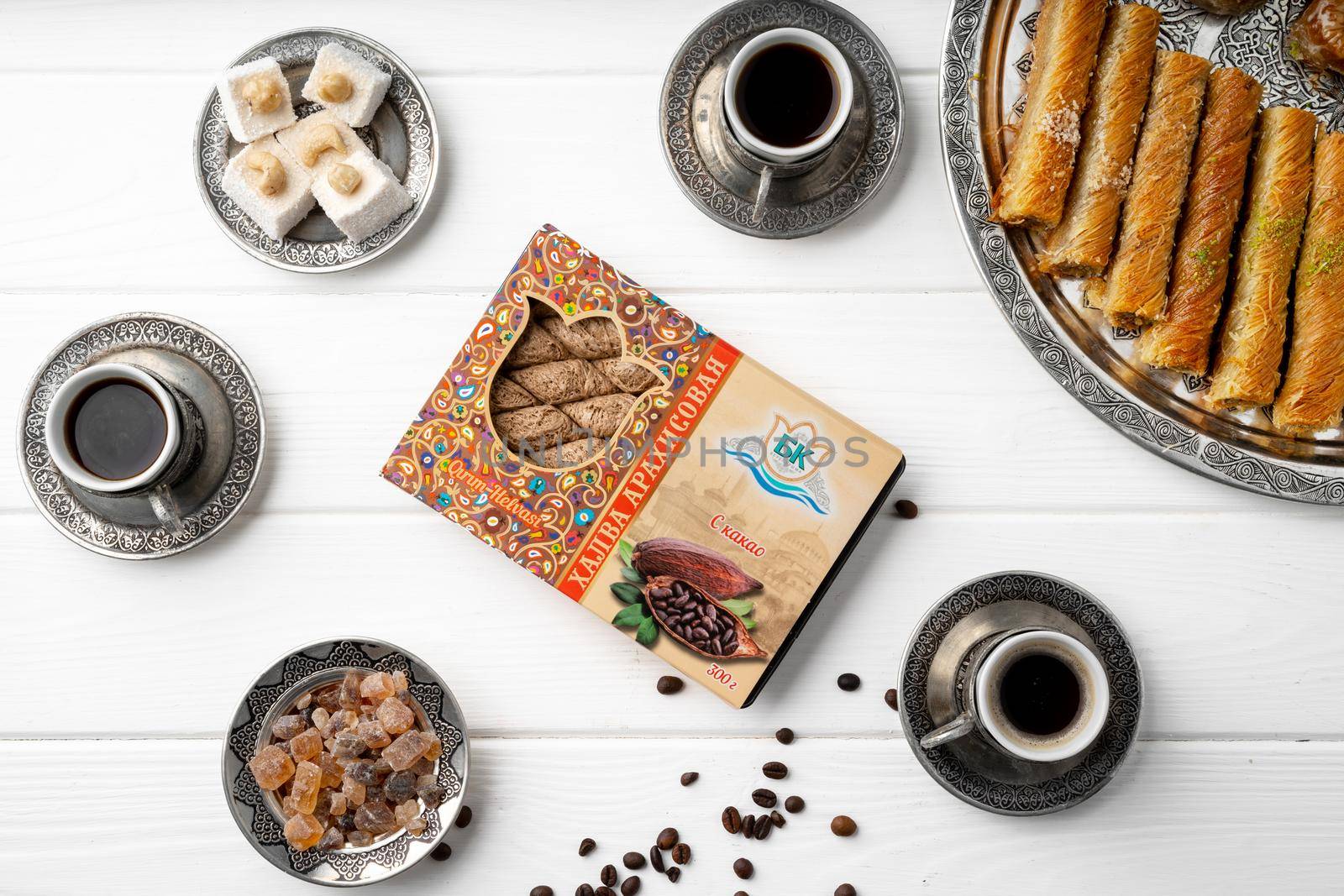 Top view of Turkish sweets and Turkish coffee on white wooden background, close up