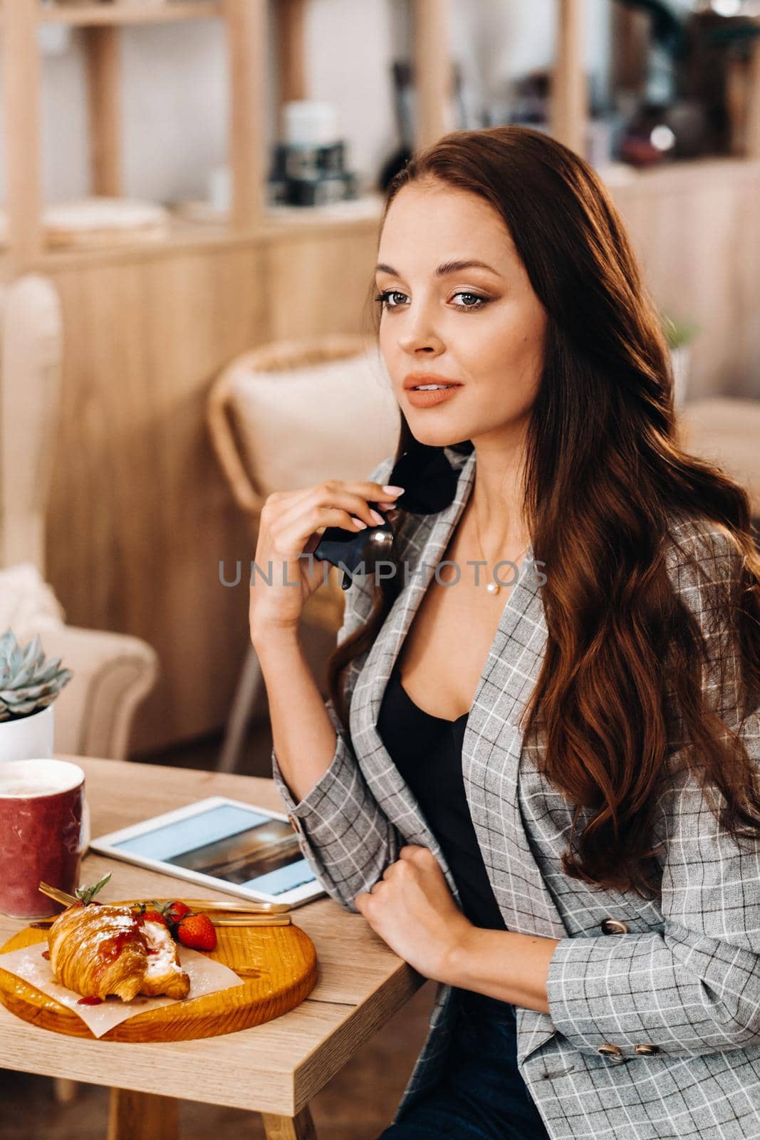portrait of an Attractive young woman who is sitting in a cafe. Cafe urban lifestyle. Random portrait by Lobachad