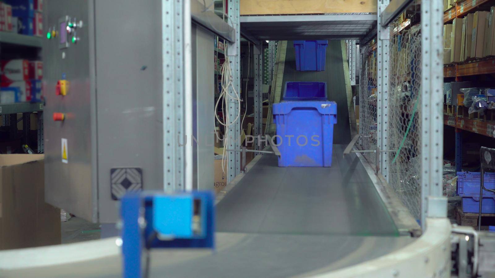 Boxes moving on the automatic conveyor. Details equipment in delivery company or warehouse.