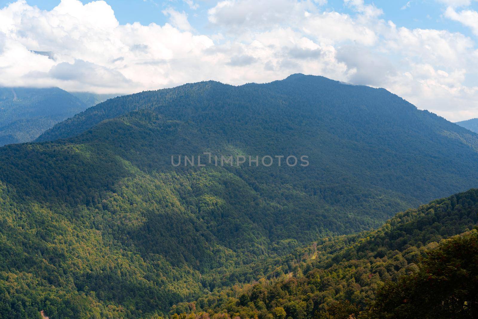Scenic green mountains and beautiful sky clouds for a background