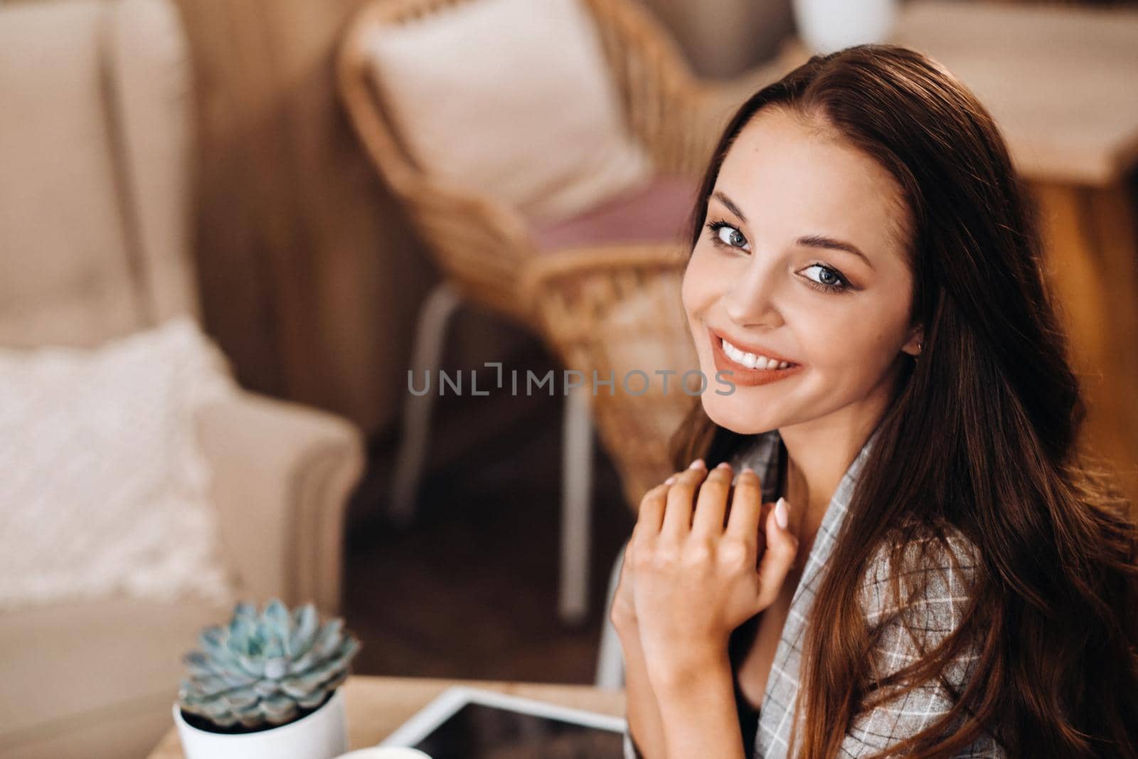 portrait of an Attractive young woman who is sitting in a cafe. Cafe urban lifestyle. Random portrait by Lobachad