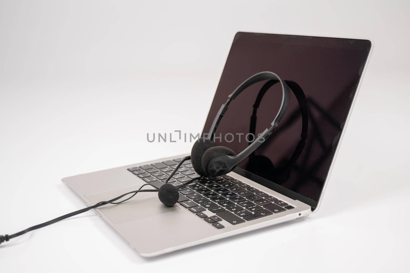 Headset on laptop keyboard on white background. by mrwed54