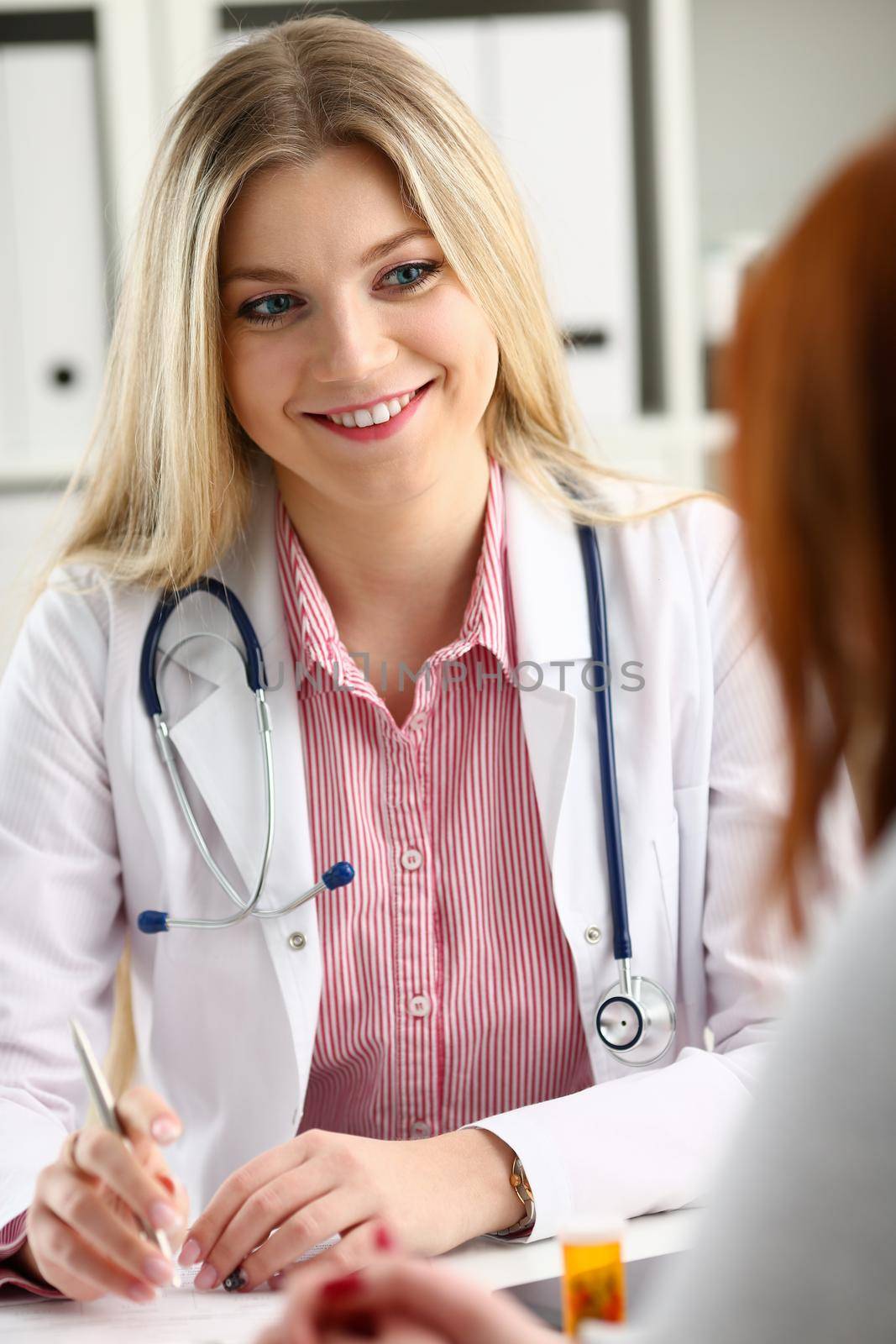 Beautiful smiling female doctor talk with patient about his history list. Physical exam er anamnesis communication disease prevention ward round 911 prescribe remedy healthy lifestyle concept