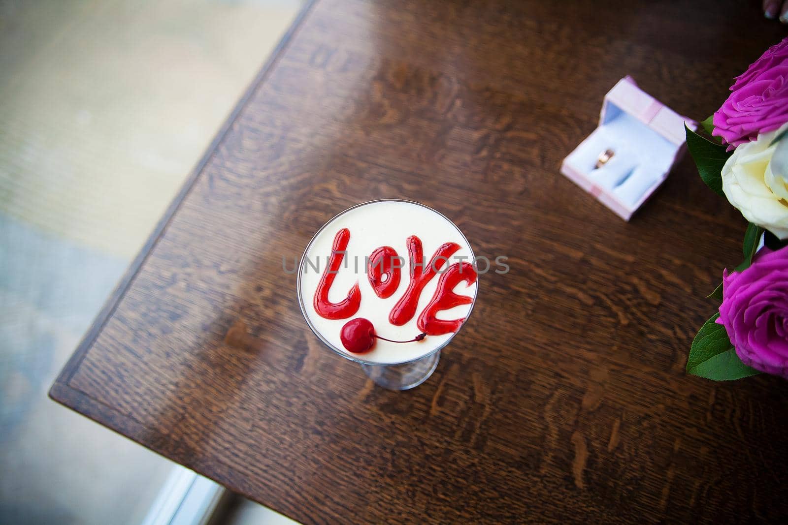 Valentine's Day dessert with the words love and cherries.