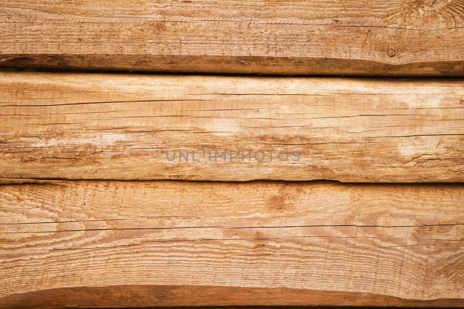 Old natural uncolored wooden wall surface. Background photo texture.