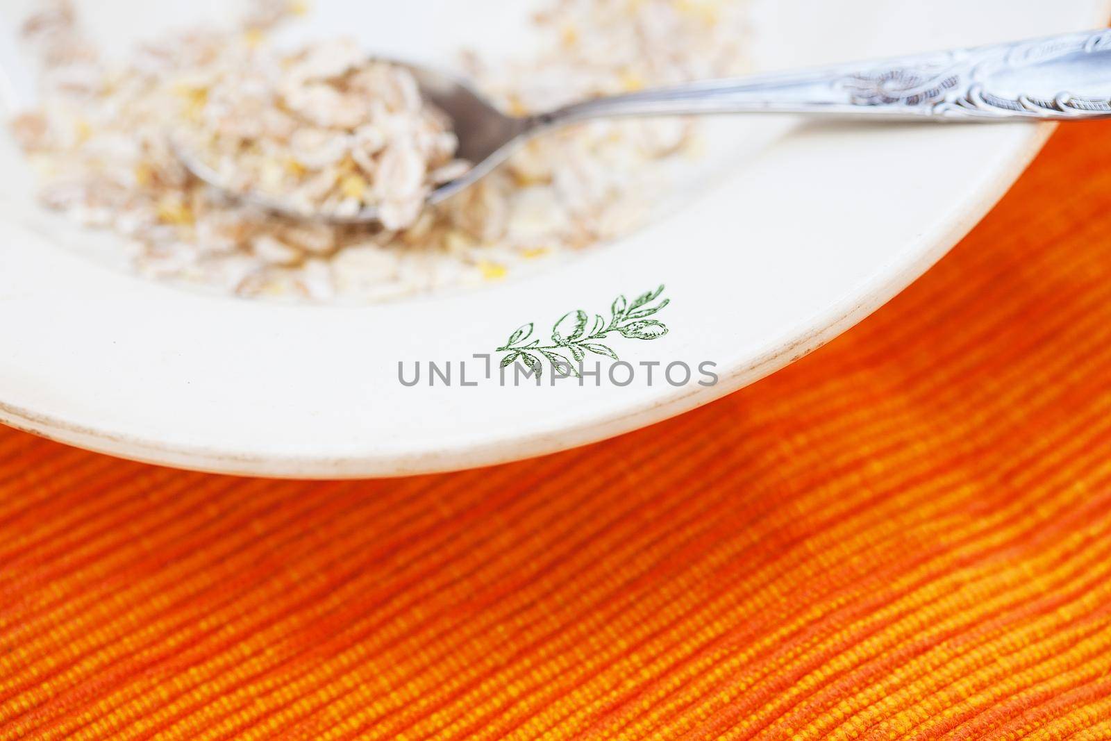 oatmeal in white bowl on orange napkin by sfinks