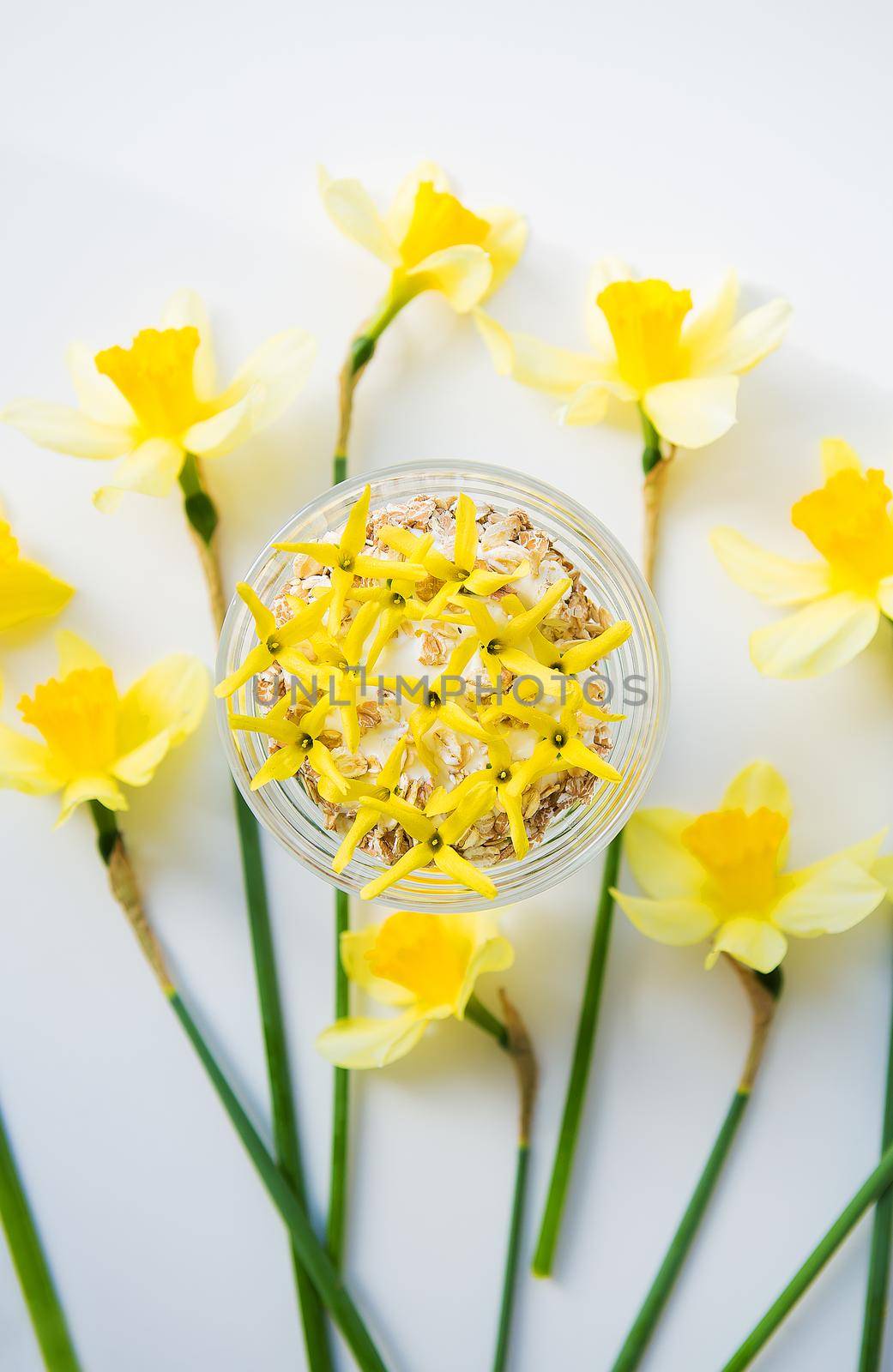 A big bouquet of daffodils and beautiful yellow flowers on the table by sfinks