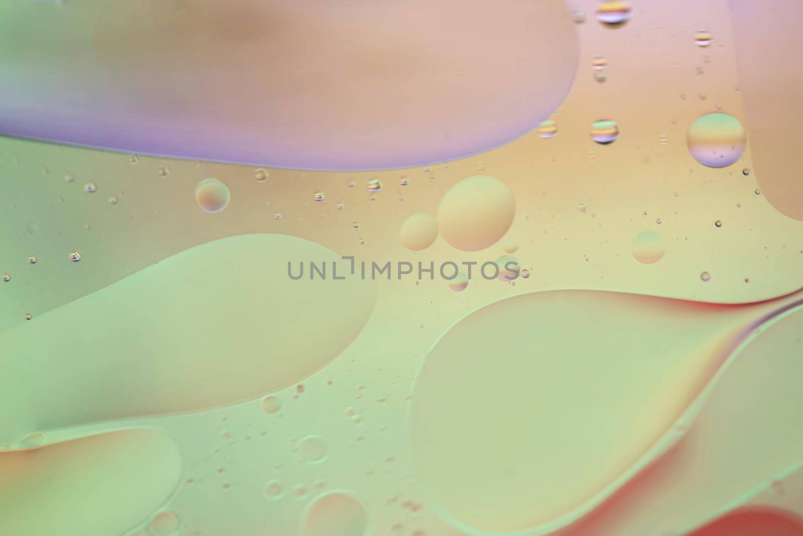 Defocused pastel colored abstract background picture made with oil, water and soap by anytka