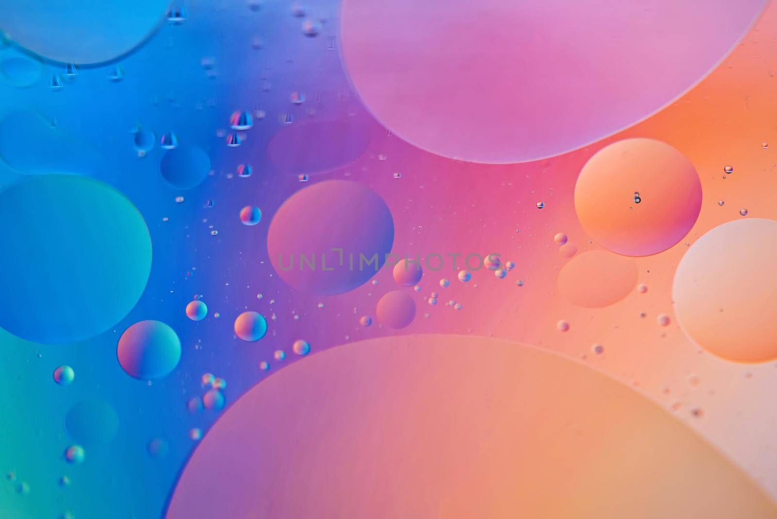 Colorful abstract background with oil drops on water. Blue orange color