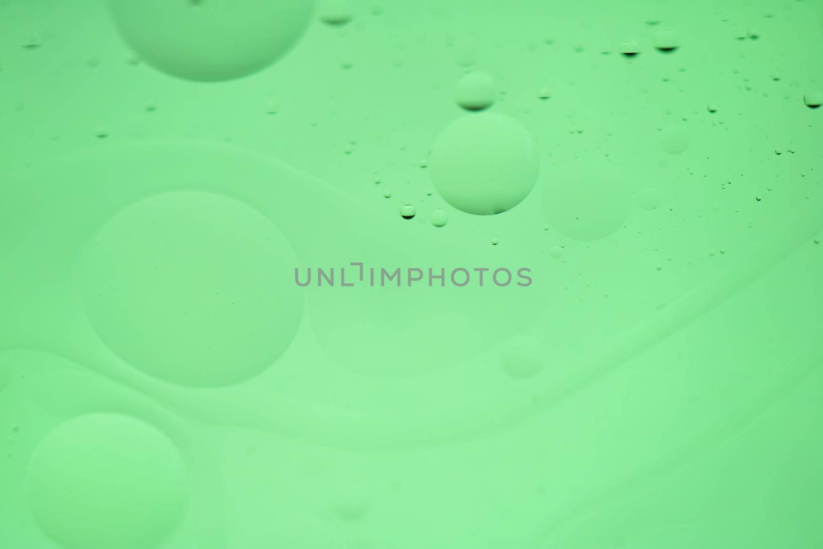 Oil drops in water. Defocused abstract psychedelic pattern image green mint colored. DOF.