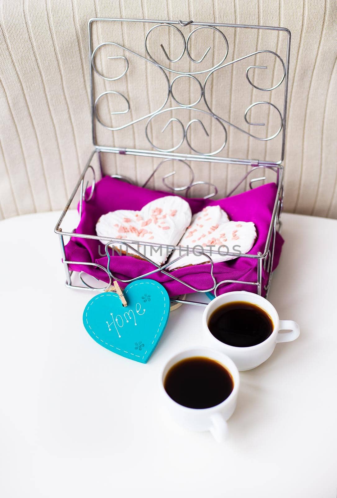 Cookies in a heart and two cups of coffee on the table that says home by sfinks