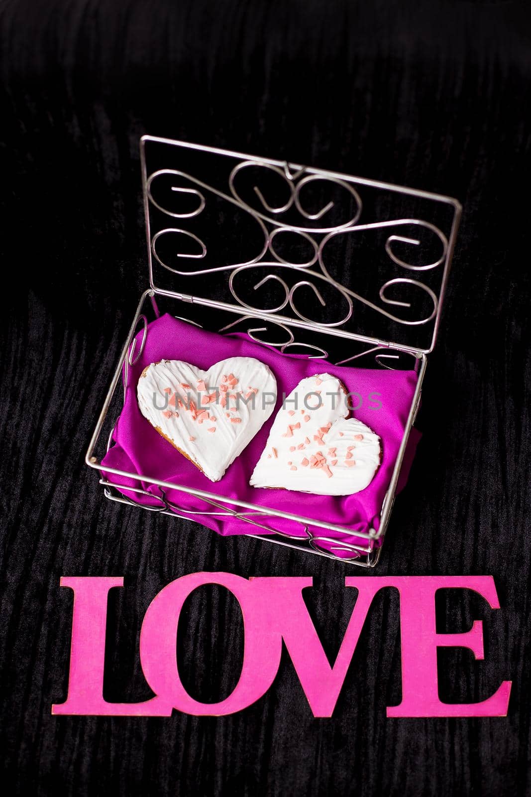 Cookies in the form of heart lies in a casket inscription love close-up by sfinks