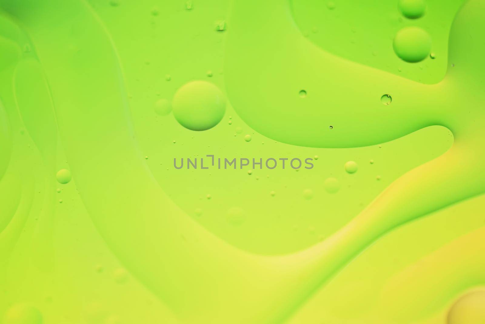Green and yellow abstract background picture made with oil, water and soap by anytka