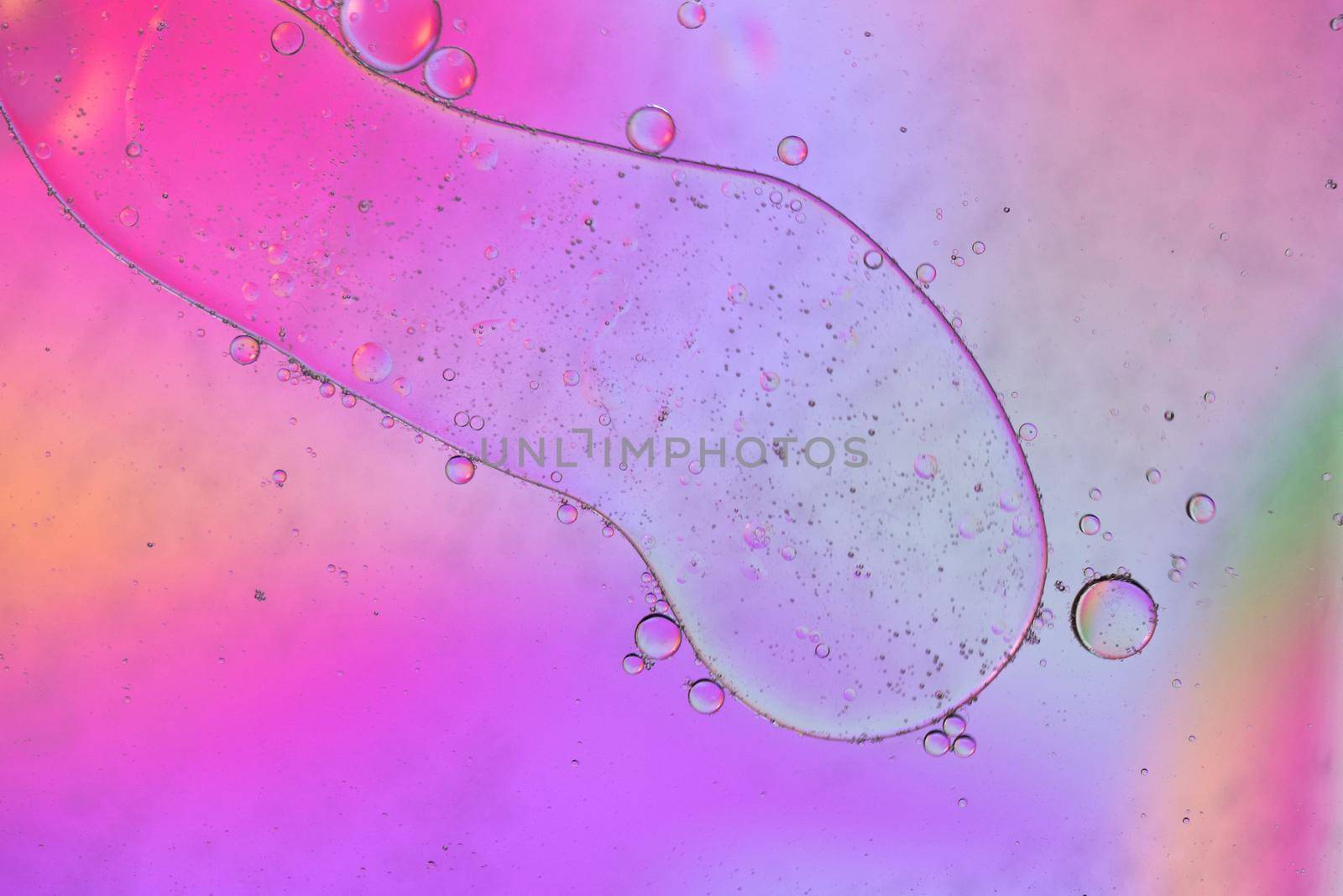 Oil drops in water. Defocused abstract psychedelic pattern image pink colored. Abstract background with colorful gradient colors. DOF.