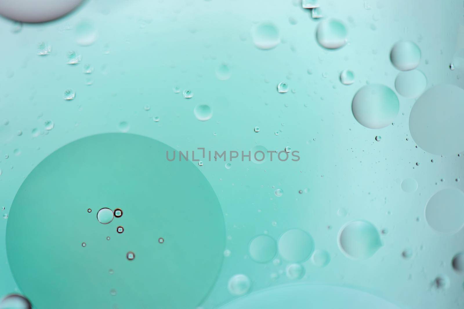 Light blue abstract background picture made with oil, water and soap by anytka