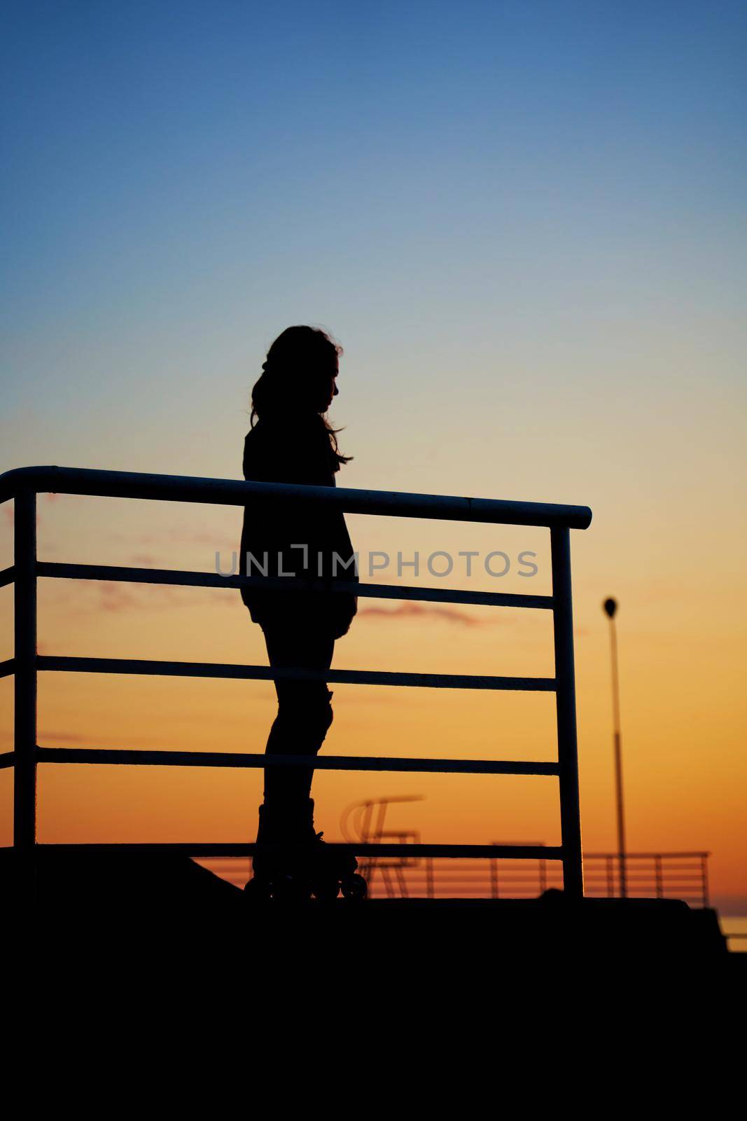 Evening sunset in the park for skaters and rollers. Silhouettes of skaters at sunset in the park.