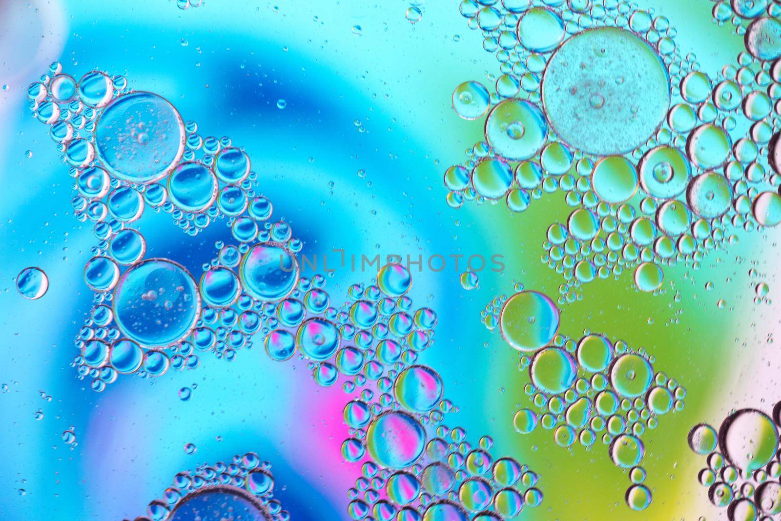 Oil drops in water in motion. Multicolored abstract defocused psychedelic pattern image with mooving boubbles . Abstract background with colorful gradient colors. DOF