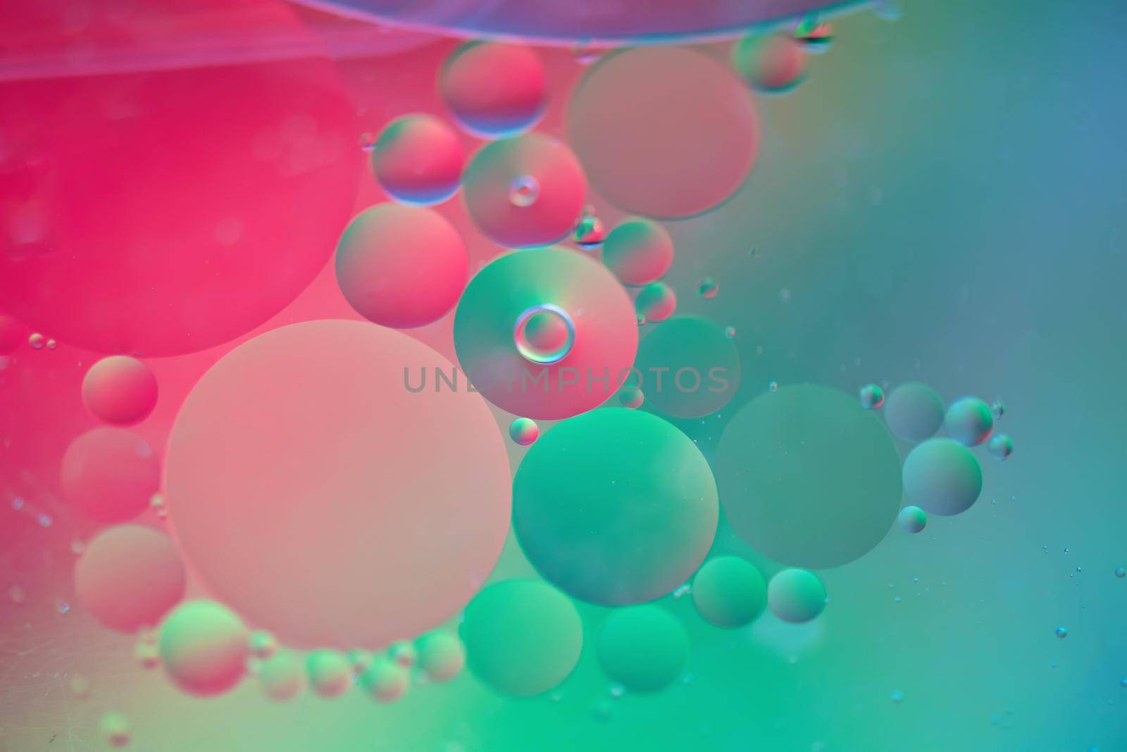 Oil drops in water. Abstract defocused psychedelic pattern image red and green colored. Abstract background with colorful gradient colors. DOF