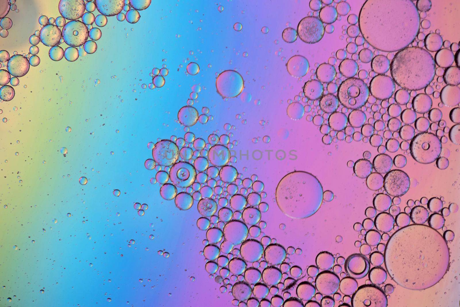 Colorful abstract background with oil drops on water. Rainbow