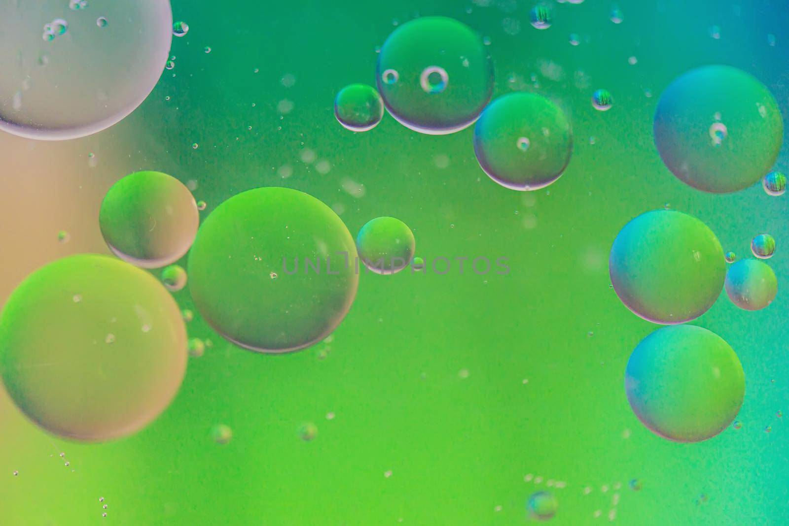 Oil drops in water. Abstract defocused psychedelic pattern image rainbow colored. Abstract background with colorful gradient colors. DOF
