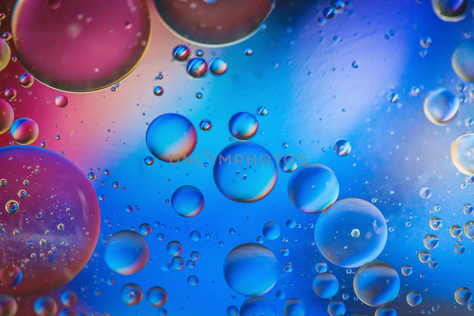 Multicolored abstract defocused background picture made with oil, water and soap by anytka