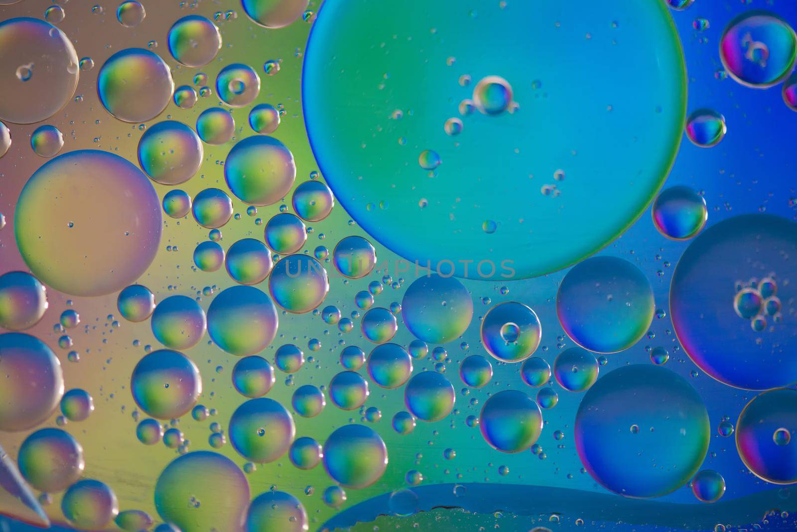 Oil drops in water. Abstract psychedelic pattern image rainbow colored. Abstract background with colorful gradient colors.