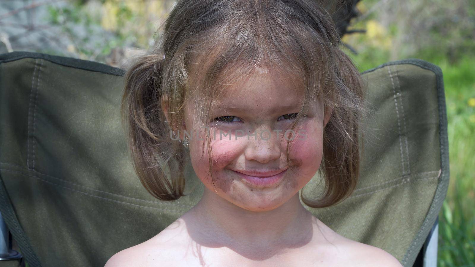 Portrait of a smiling little girl. Tiny kid have fun, enjoy nature outdoors.