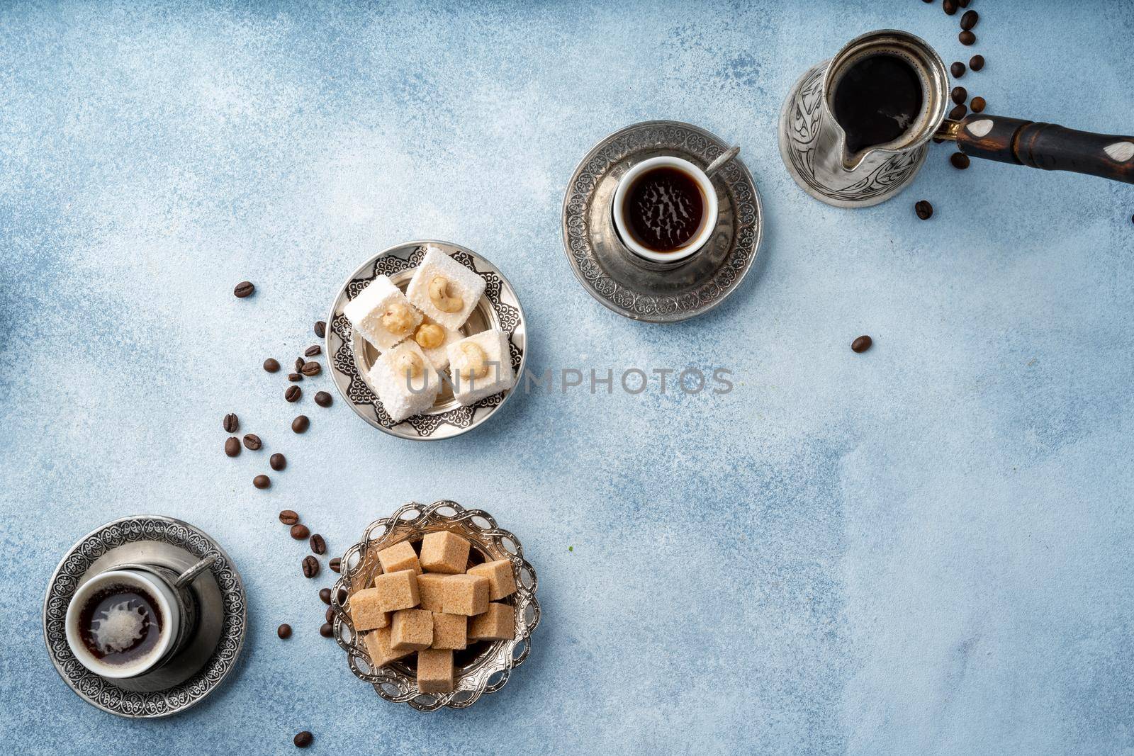 Top view photo of Turkish delight and brown cubed sugar in oriental dishware on table