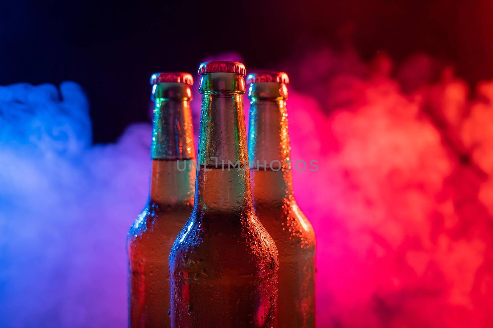 Three bottles of beer in a blue-pink mist. by mrwed54