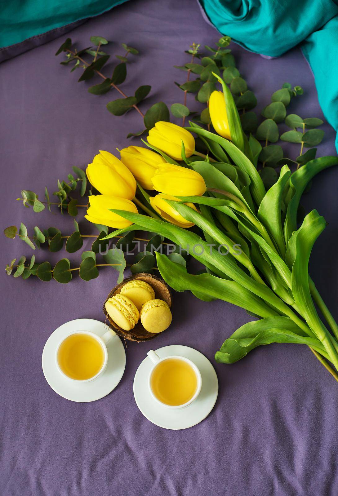 yellow tulips, cookies and two cups of tea in bed. valentine card