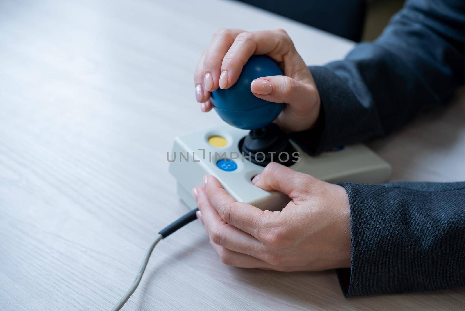 Woman with cerebral palsy works on a specialized computer mouse