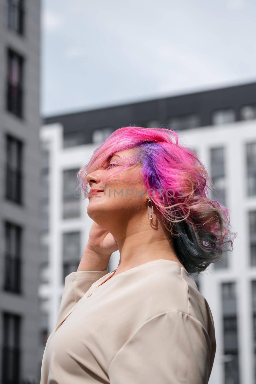 Close-up portrait of curly Caucasian woman with multi-colored hair. Model for hairstyles by mrwed54